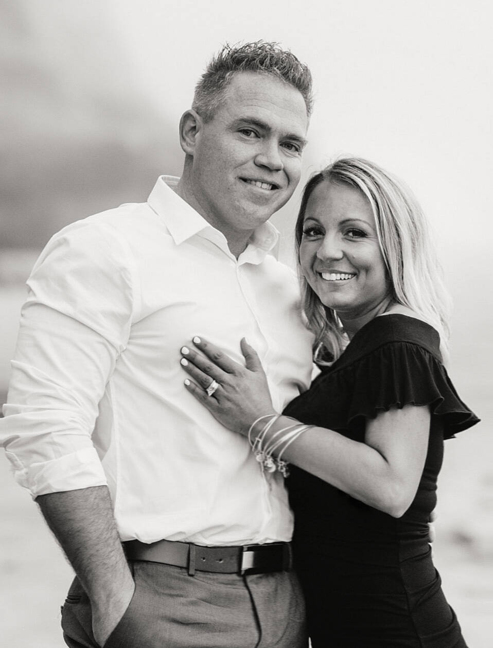 Doug and Cam standing together in a black-and-white portrait